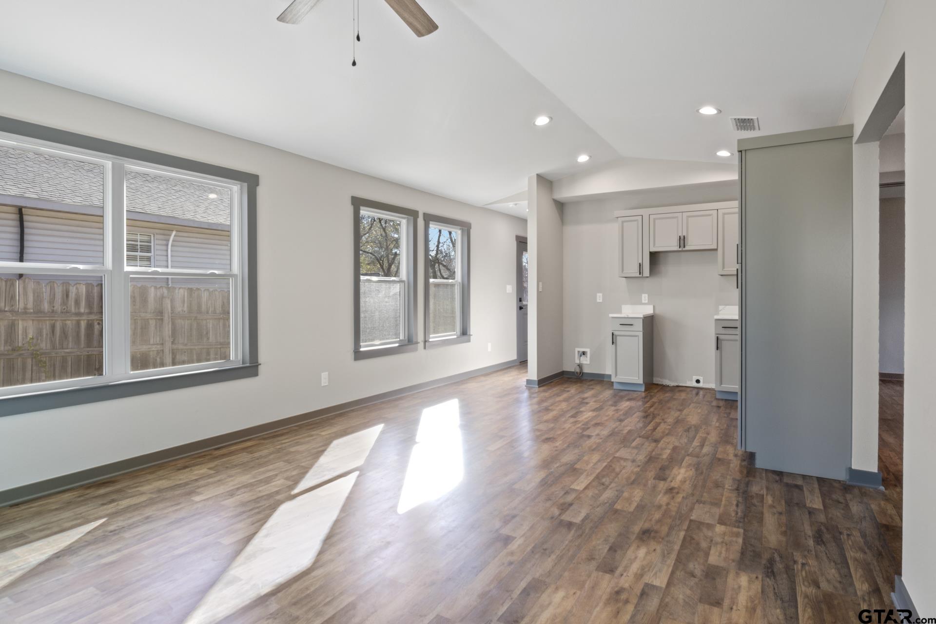 109 Yates Street Mount Vernon, TX 75457 - Photo 4 of 23 a view of empty room with wooden floor and windows
