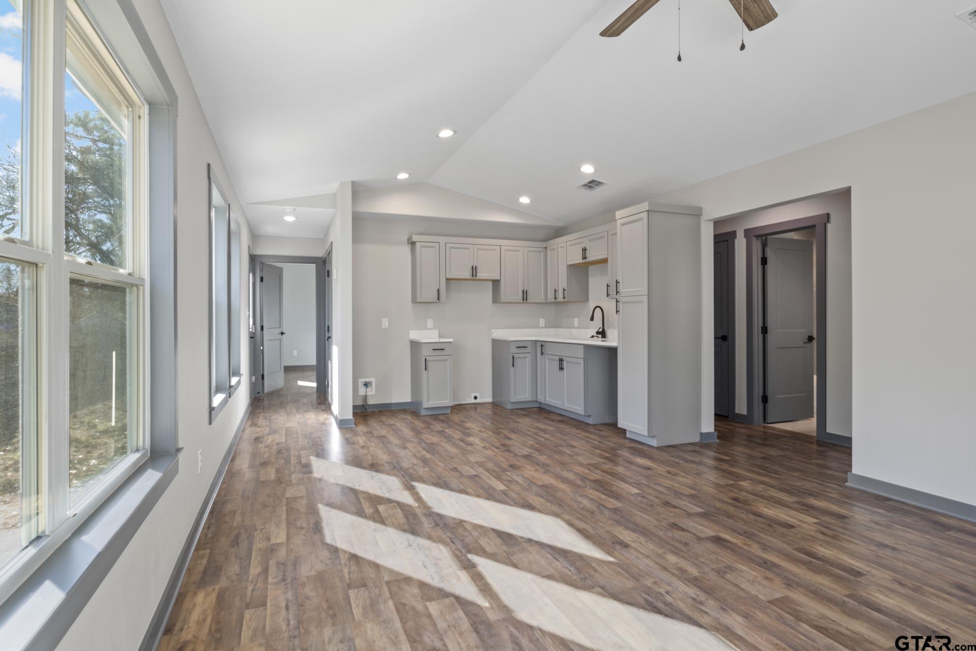 109 Yates Street Mount Vernon, TX 75457 - Photo 5 of 23 a view of a kitchen with kitchen island wooden floor center island and stainless steel appliances