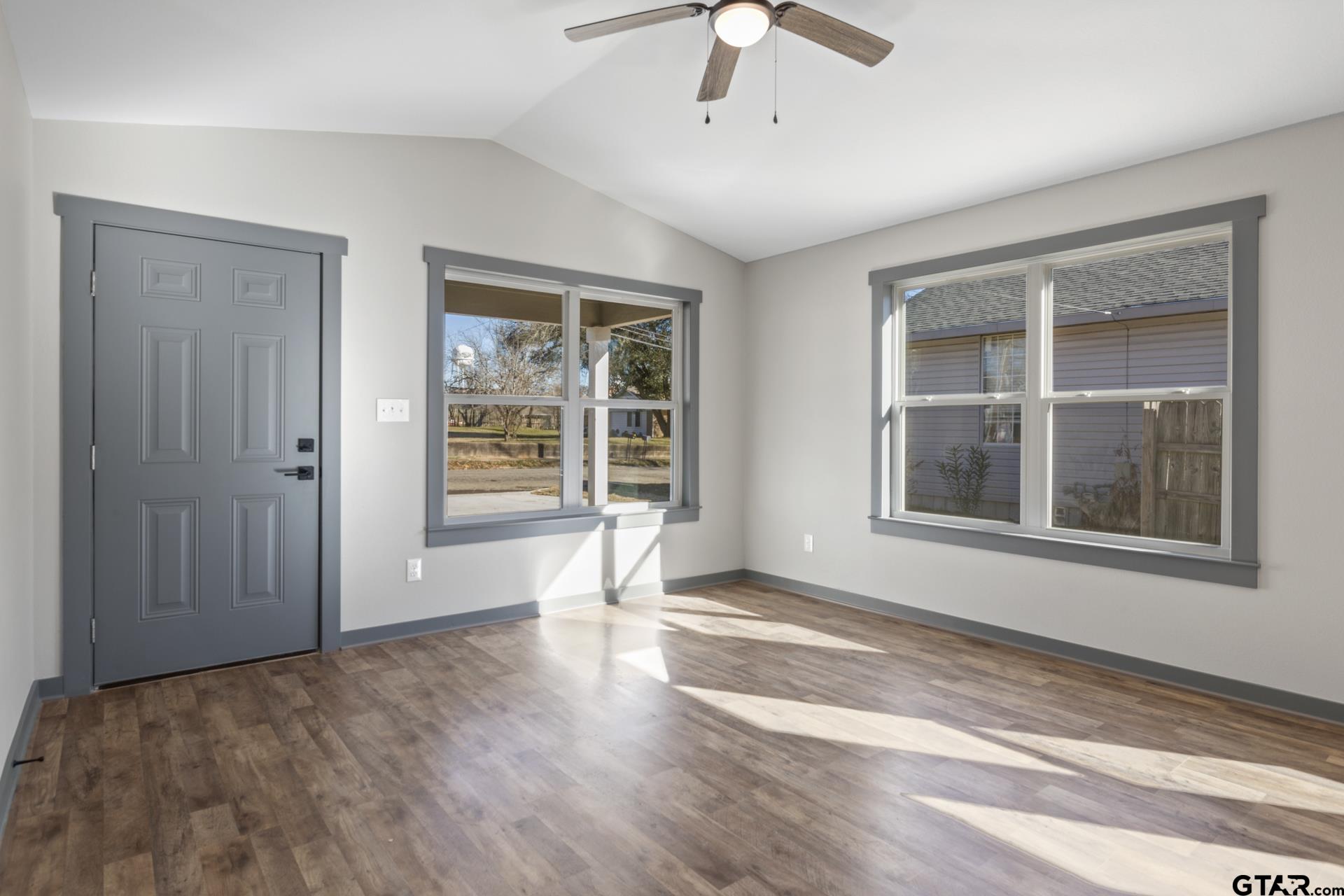 109 Yates Street Mount Vernon, TX 75457 - Photo 7 of 23 a view of an empty room with a window and wooden floor