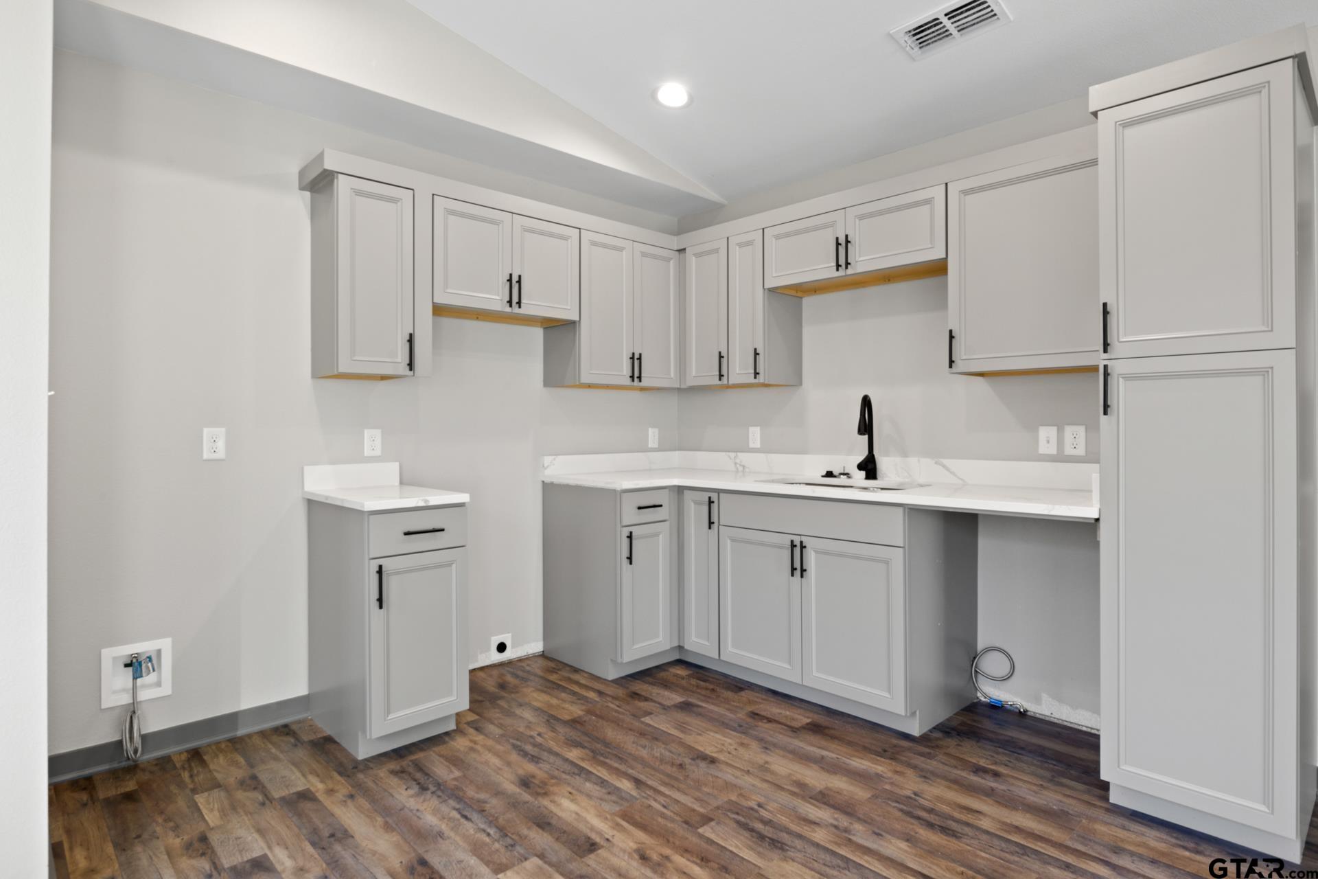 109 Yates Street Mount Vernon, TX 75457 - Photo 8 of 23 a kitchen with a sink cabinets and wooden floor