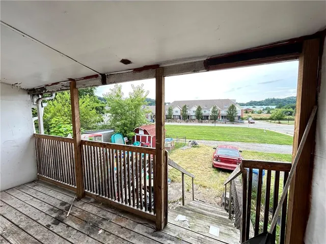 a view of two chairs in the balcony