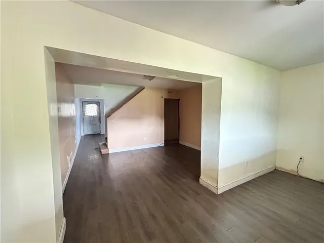 a view of a hallway with wooden floor