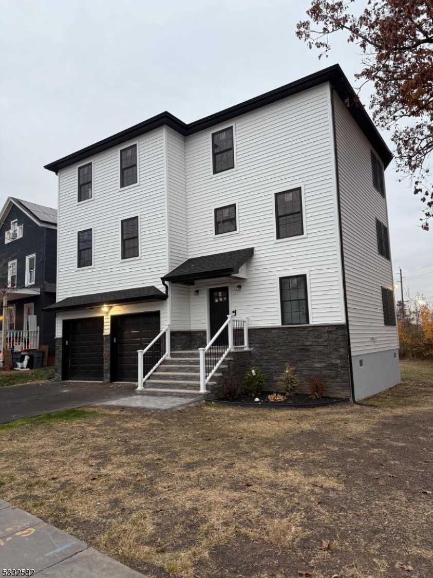 7 Maple Street Bloomfield, NJ 07003 - Photo 1 of 13 a front view of a house with a yard