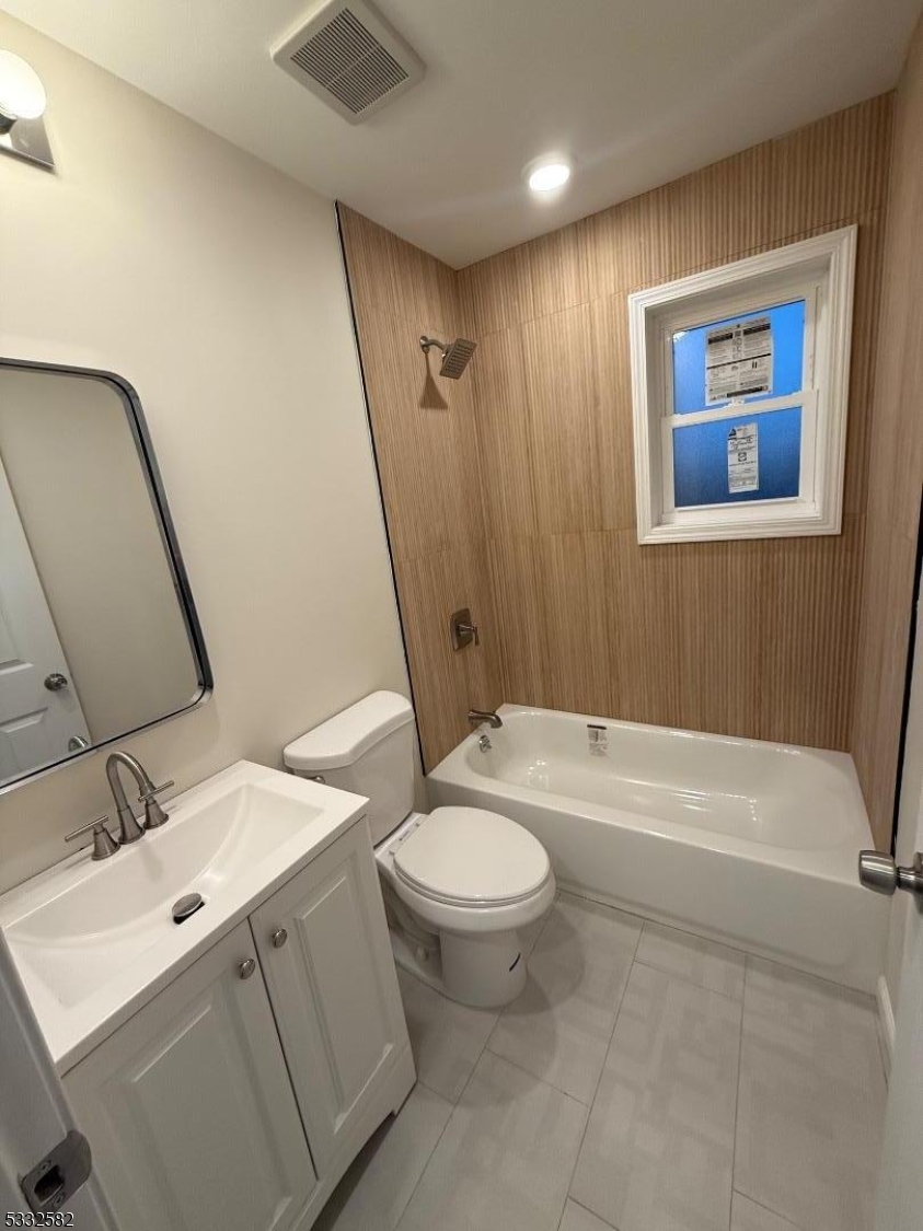 7 Maple Street Bloomfield, NJ 07003 - Photo 11 of 13 a bathroom with a sink a toilet and a mirror