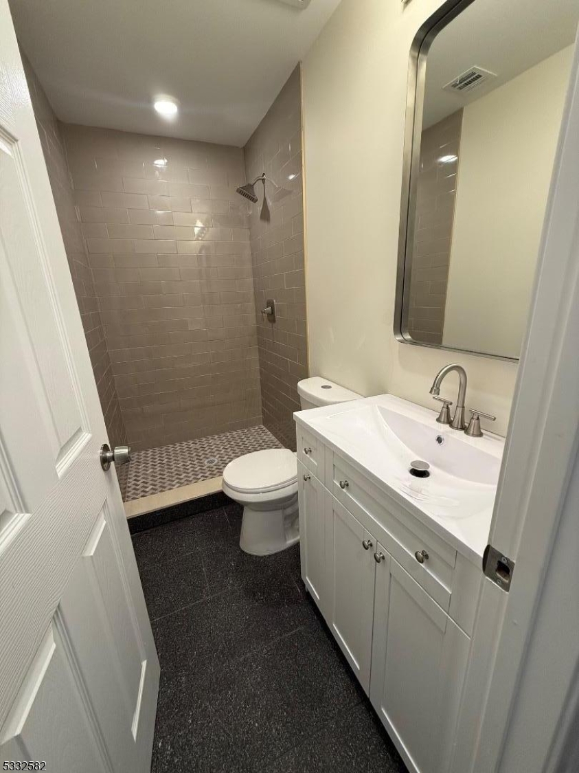 7 Maple Street Bloomfield, NJ 07003 - Photo 12 of 13 a bathroom with a sink a toilet and shower