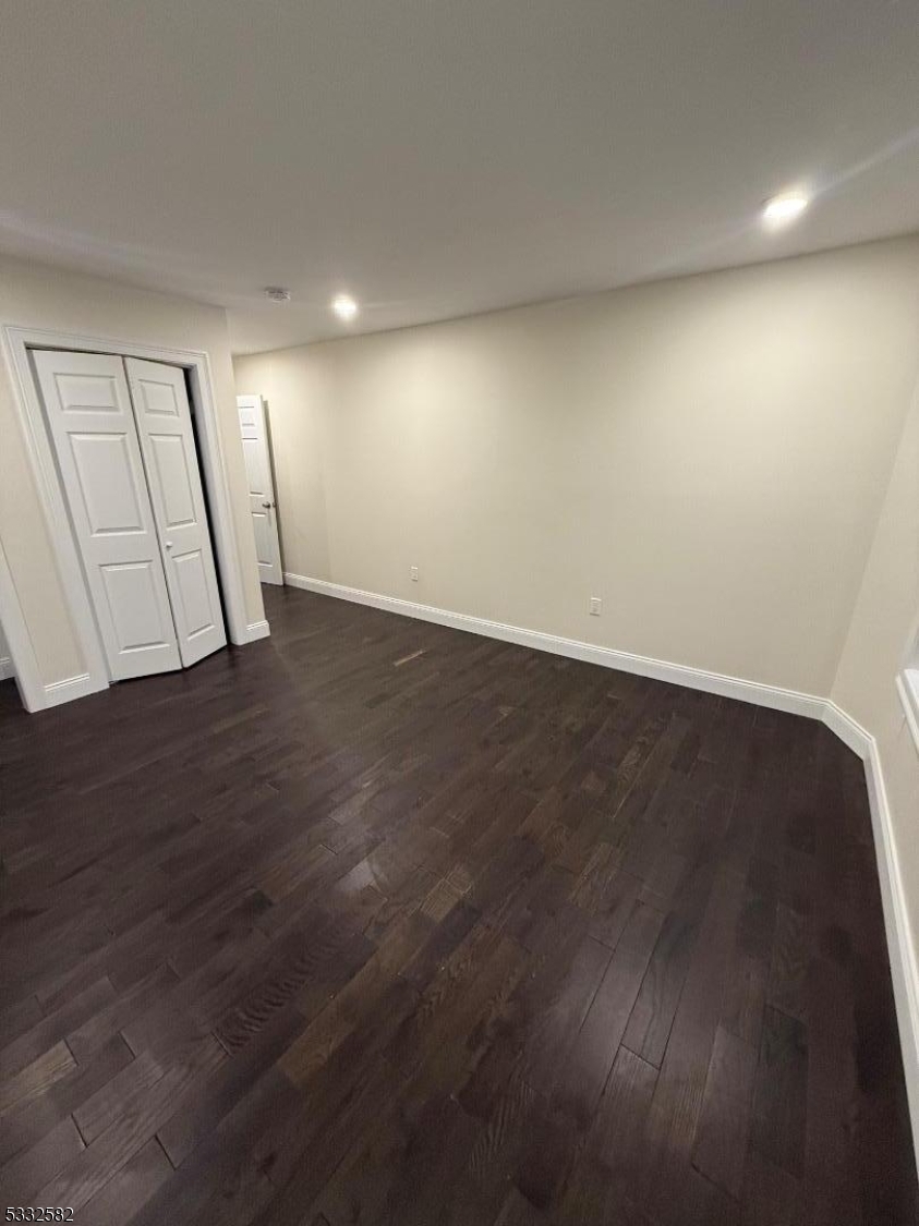 7 Maple Street Bloomfield, NJ 07003 - Photo 13 of 13 an empty room with wooden floor and natural light