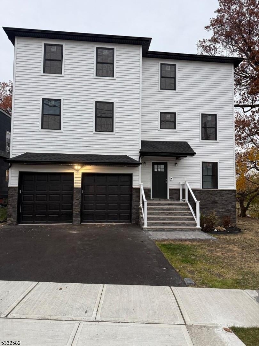 7 Maple Street Bloomfield, NJ 07003 - Photo 2 of 13 front view of a house with a yard