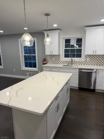 a view of a kitchen with a stove and kitchen island