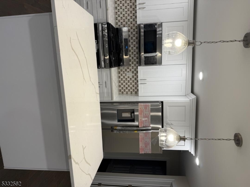 7 Maple Street Bloomfield, NJ 07003 - Photo 5 of 13 a bathroom with a sink and a mirror