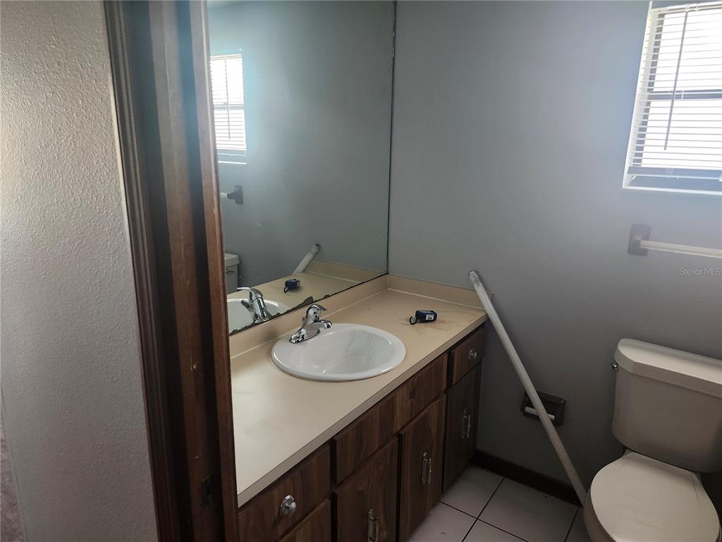 6141 Freeport Drive Spring Hill, FL 34606 - Photo 11 of 28 a bathroom with a granite countertop toilet sink and mirror