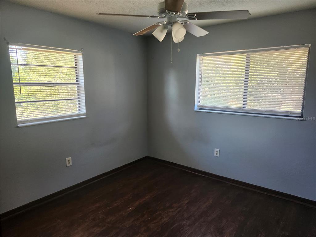 6141 Freeport Drive Spring Hill, FL 34606 - Photo 16 of 28 a view of an empty room with wooden floor and a window