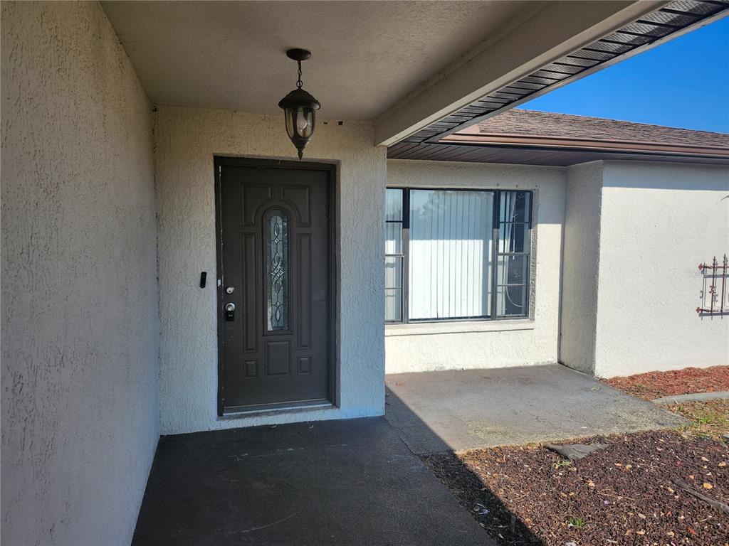 6141 Freeport Drive Spring Hill, FL 34606 - Photo 6 of 28 a view of a hallway with a chandelier