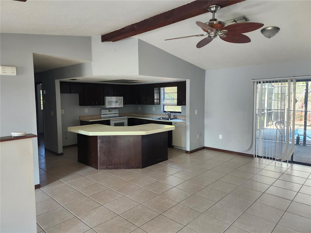 6141 Freeport Drive Spring Hill, FL 34606 - Photo 9 of 28 a room with a couch and a stove