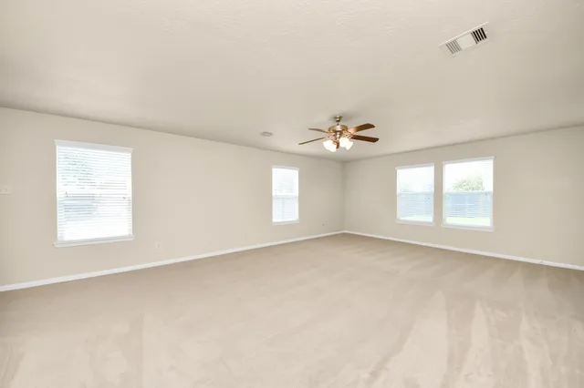 a view of a kitchen with a sink wooden cabinets and a refrigerator