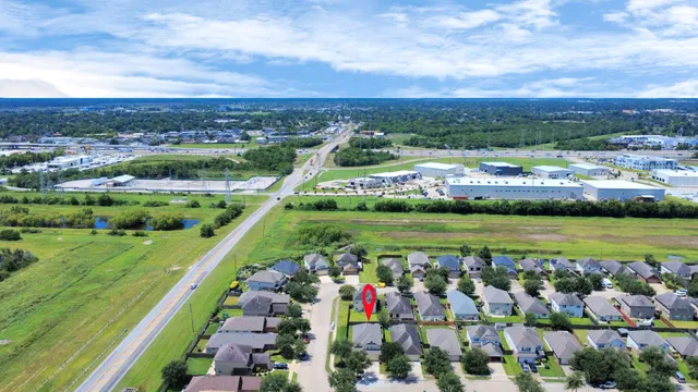 a view of a swimming pool with a yard and large trees