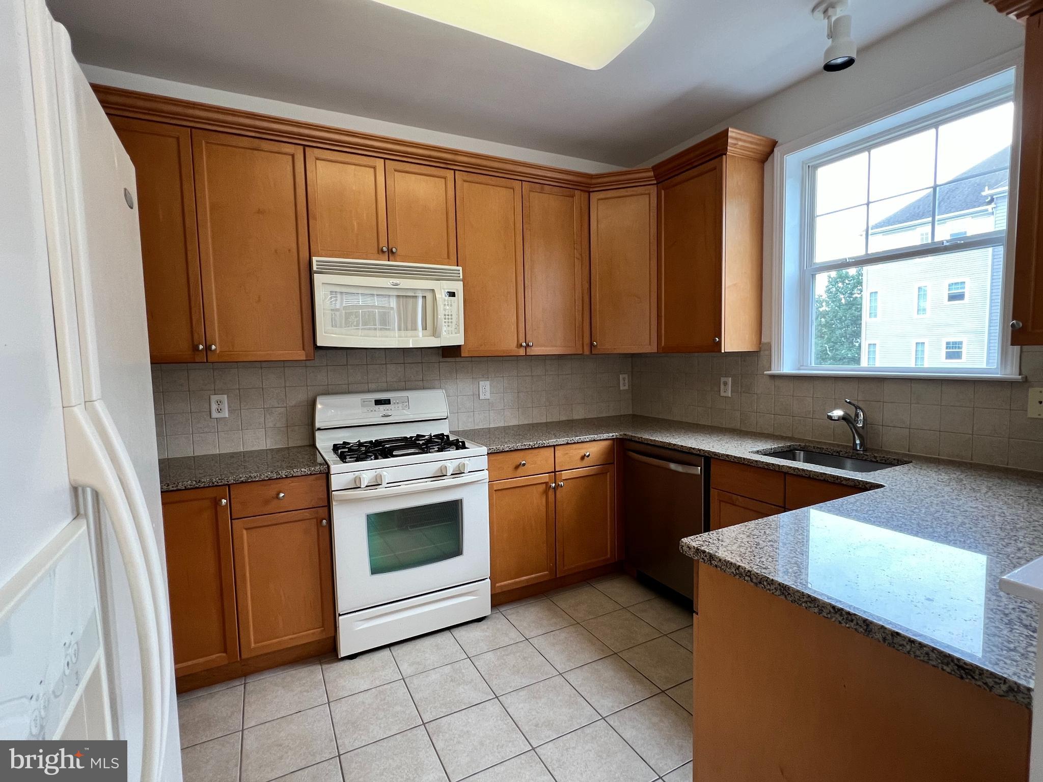 422 Masterson Court Ewing, NJ 08618 - Photo 14 of 29 a kitchen with stainless steel appliances granite countertop a stove a sink and a microwave