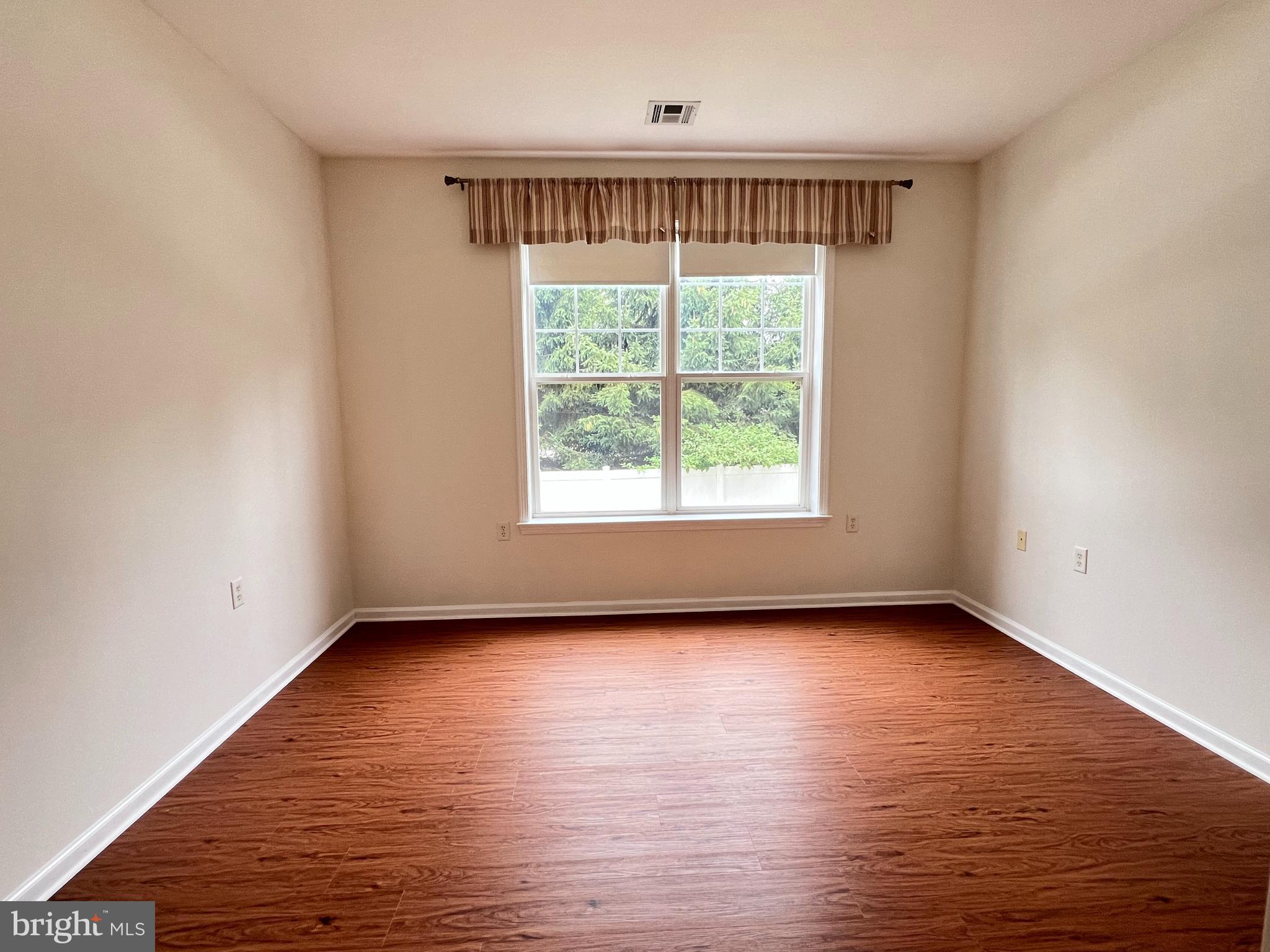 422 Masterson Court Ewing, NJ 08618 - Photo 18 of 29 a view of an empty room with wooden floor and a window