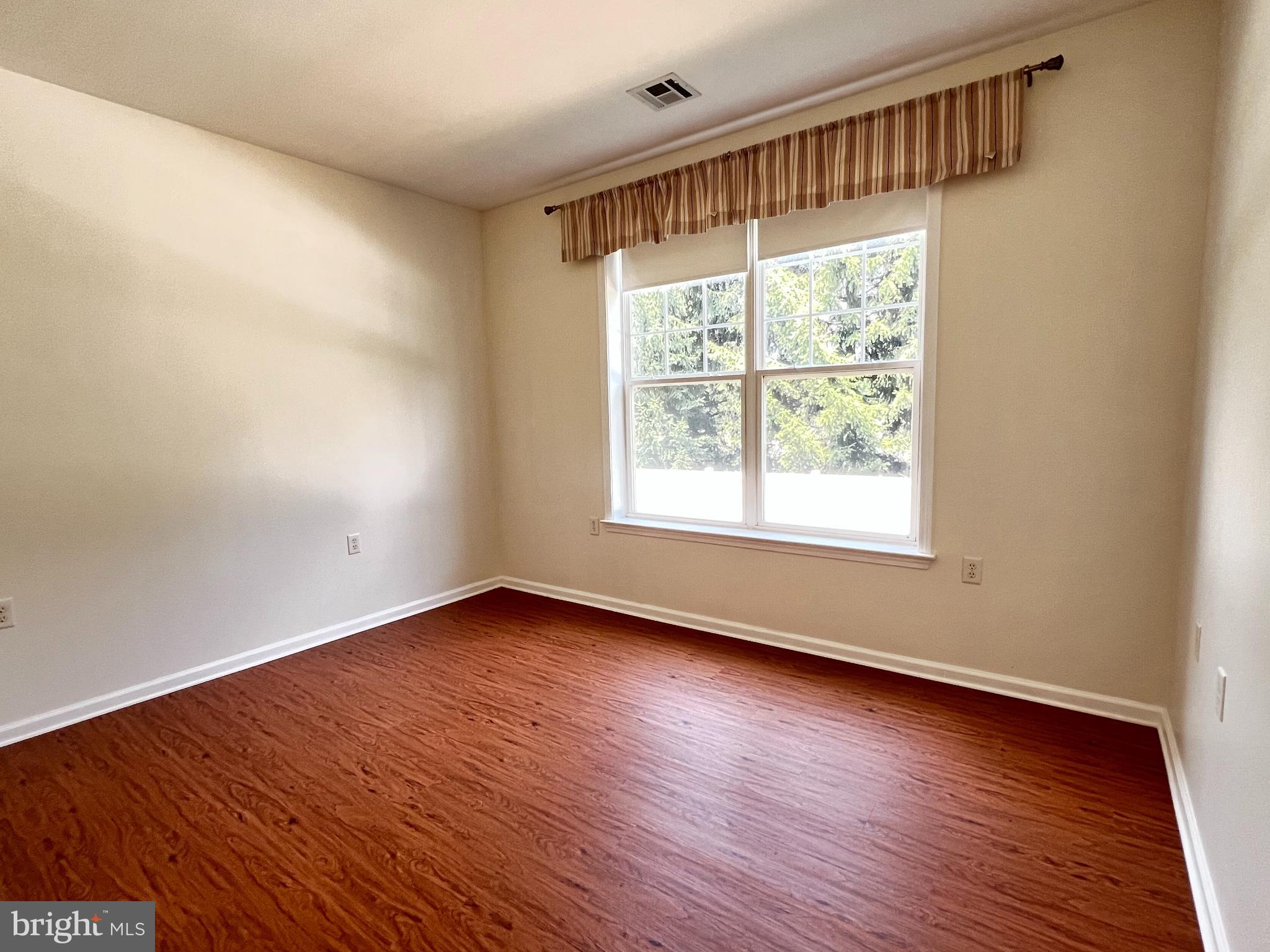 422 Masterson Court Ewing, NJ 08618 - Photo 19 of 29 a view of an empty room with wooden floor and a window