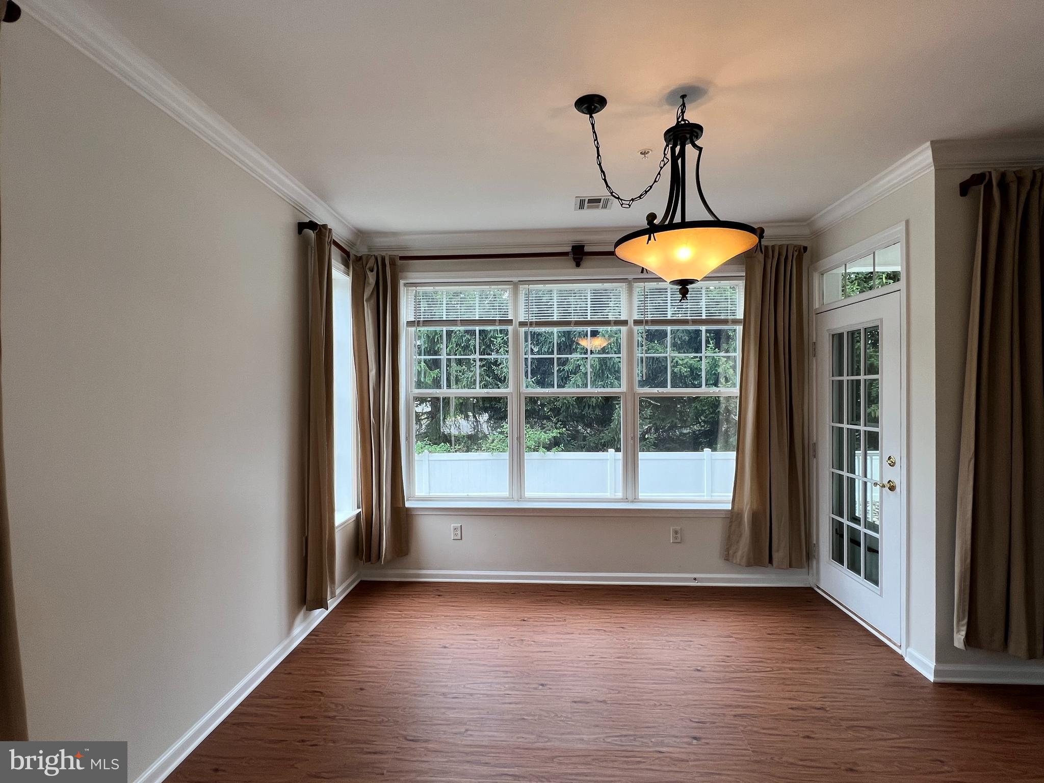 422 Masterson Court Ewing, NJ 08618 - Photo 10 of 29 a view of an empty room with wooden floor and a window