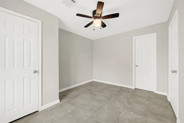 an empty room with ceiling fan