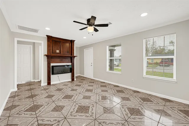 a view of empty room with window and fireplace