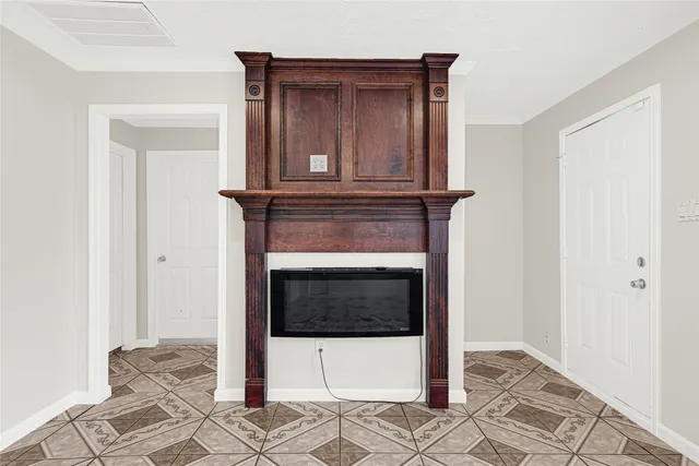a living room with a fireplace and a rug