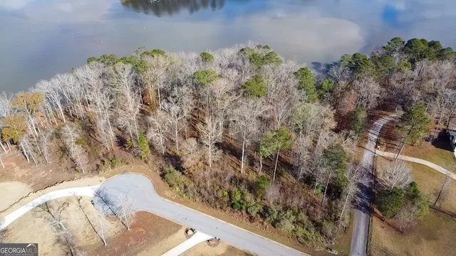 an aerial view of a house with a lake view