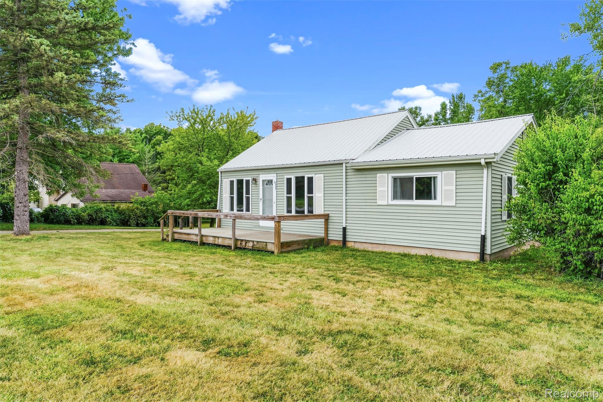 6163 North State Road Davison, MI 48423 - Photo 10 of 45 Light green siding exterior with a metal roof