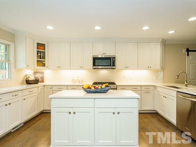 3317 Redbud Lane Raleigh, NC 27607 - Photo 11 of 25 a kitchen with a sink stove top oven and cabinets