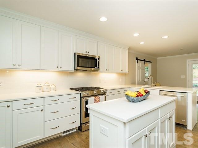 3317 Redbud Lane Raleigh, NC 27607 - Photo 12 of 25 a kitchen with a sink a stove and cabinets