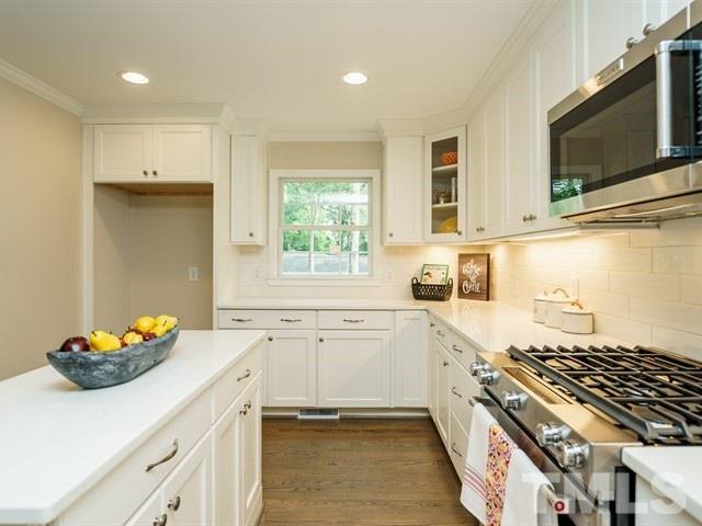3317 Redbud Lane Raleigh, NC 27607 - Photo 13 of 25 a kitchen with a sink stove and microwave