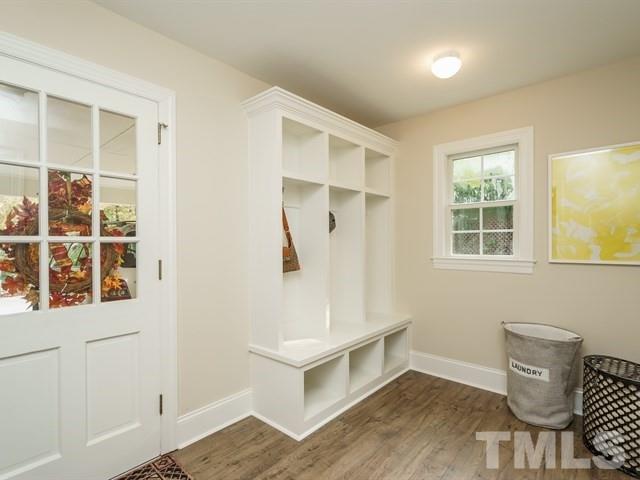 3317 Redbud Lane Raleigh, NC 27607 - Photo 14 of 25 a view of an empty room with a window and wooden floor