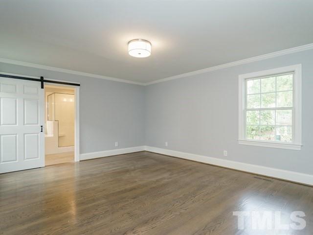 3317 Redbud Lane Raleigh, NC 27607 - Photo 16 of 25 an empty room with wooden floor and windows