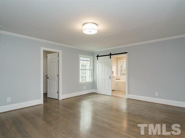 3317 Redbud Lane Raleigh, NC 27607 - Photo 17 of 25 a view of an empty room with wooden floor and a window