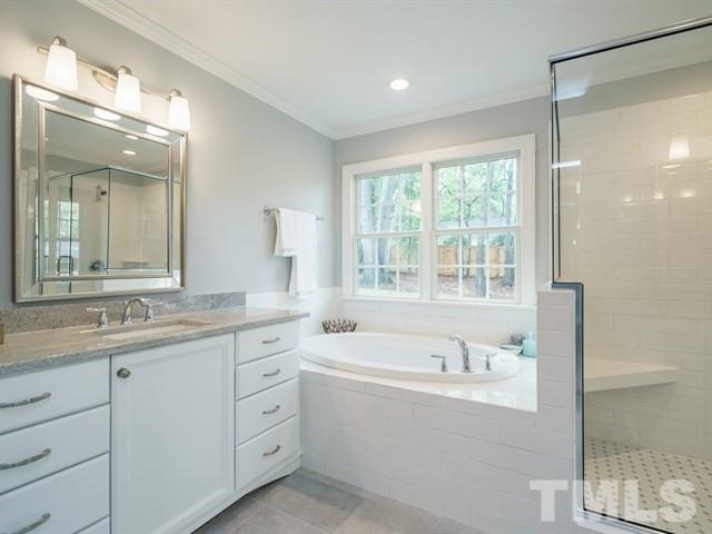 3317 Redbud Lane Raleigh, NC 27607 - Photo 18 of 25 a spacious bathroom with a granite countertop tub sink shower and mirror