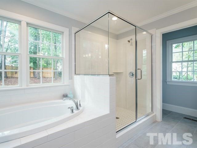 3317 Redbud Lane Raleigh, NC 27607 - Photo 19 of 25 a bathroom with a bathtub and a shower