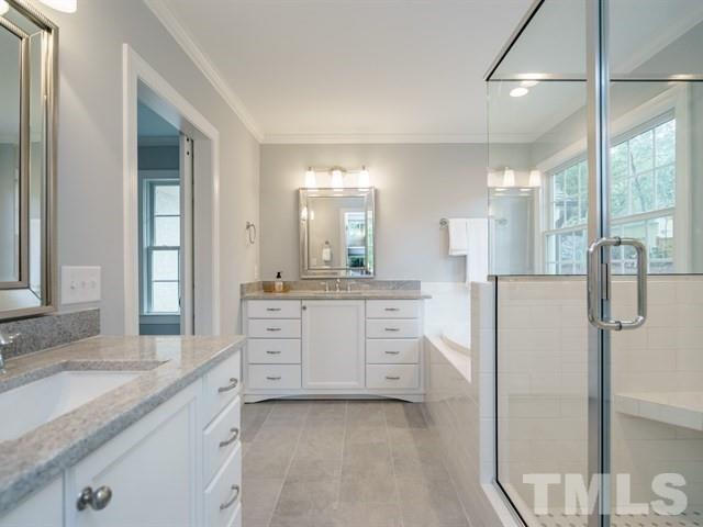 3317 Redbud Lane Raleigh, NC 27607 - Photo 20 of 25 a large bathroom with a sink a large mirror and a shower