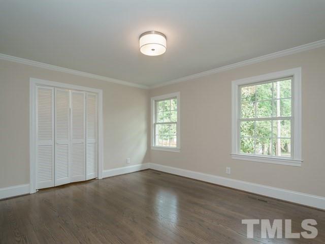 3317 Redbud Lane Raleigh, NC 27607 - Photo 22 of 25 a view of an empty room with wooden floor and a window