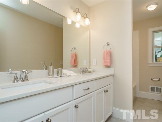 3317 Redbud Lane Raleigh, NC 27607 - Photo 23 of 25 a bathroom with a sink and a mirror