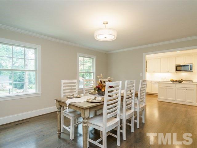 3317 Redbud Lane Raleigh, NC 27607 - Photo 4 of 25 a view of a dining room with furniture and wooden floor