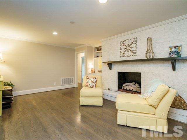 3317 Redbud Lane Raleigh, NC 27607 - Photo 5 of 25 a living room with furniture and a fireplace