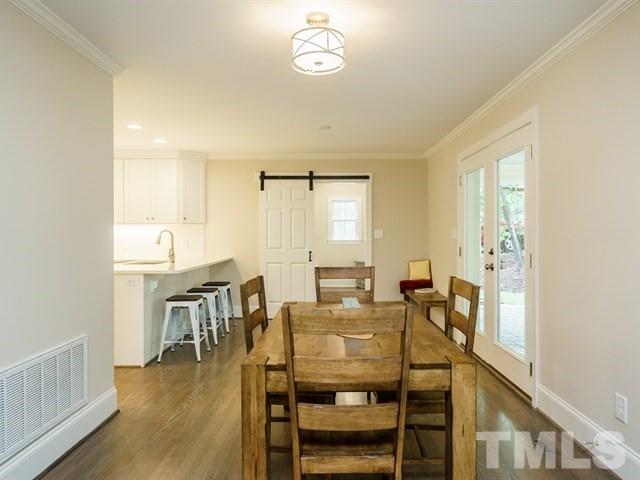 3317 Redbud Lane Raleigh, NC 27607 - Photo 8 of 25 a view of a dining room with furniture and wooden floor