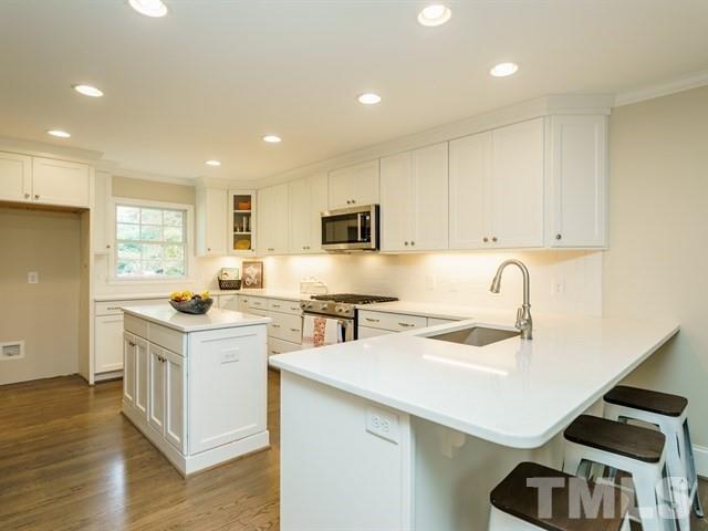 3317 Redbud Lane Raleigh, NC 27607 - Photo 10 of 25 a kitchen with a sink a stove and cabinets