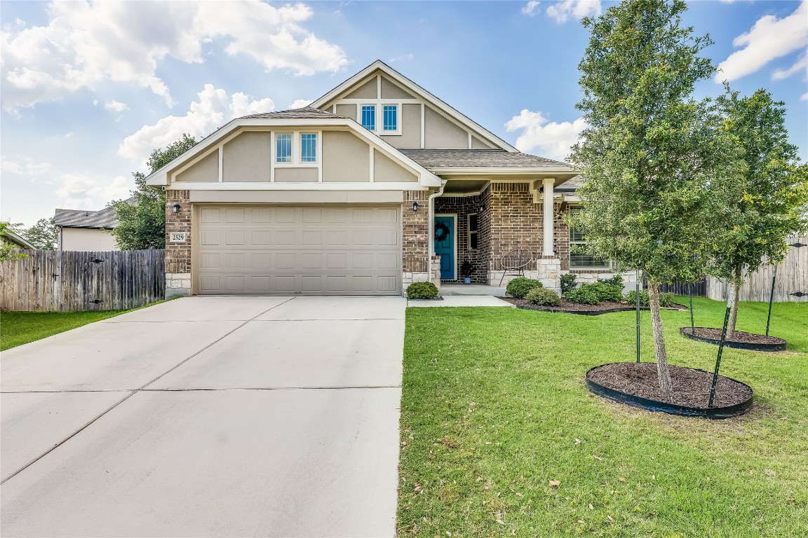 a front view of a house with a yard