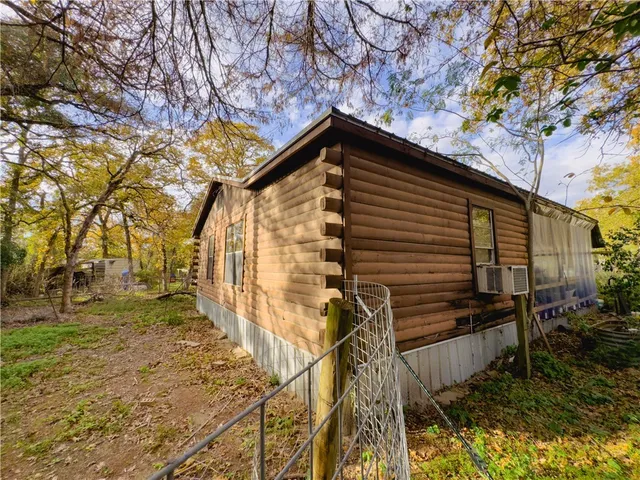 a backyard of a house with lots of trees