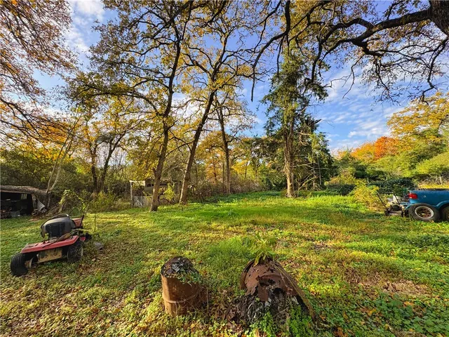 a backyard of a house with a yard and outdoor seating