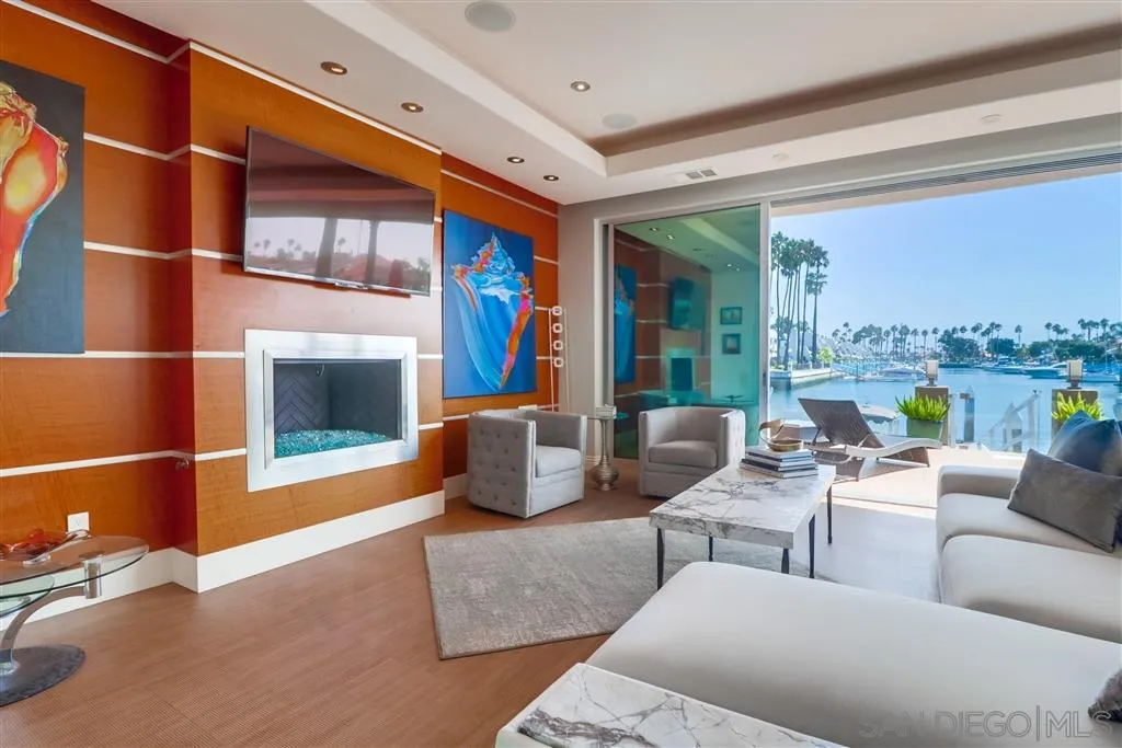 22 Green Turtle Road Coronado, CA 92118 - Photo 4 of 25 a living room with fireplace furniture and a floor to ceiling window