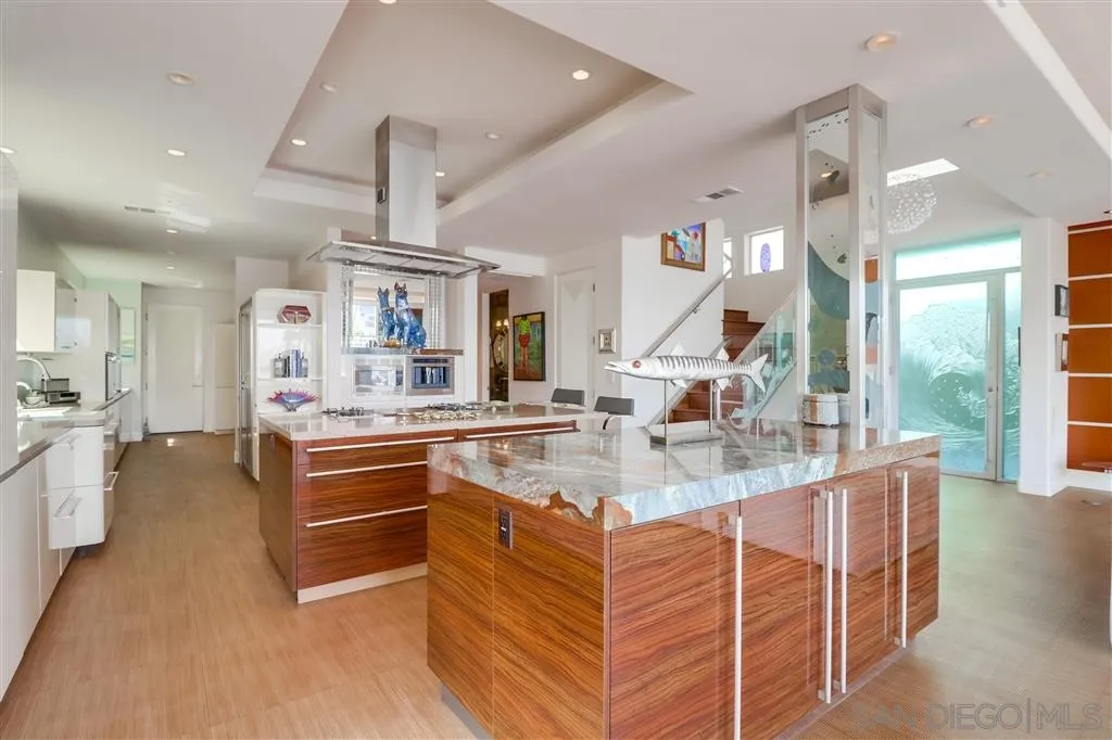 22 Green Turtle Road Coronado, CA 92118 - Photo 7 of 25 a kitchen with stainless steel appliances kitchen island granite countertop a sink and cabinets