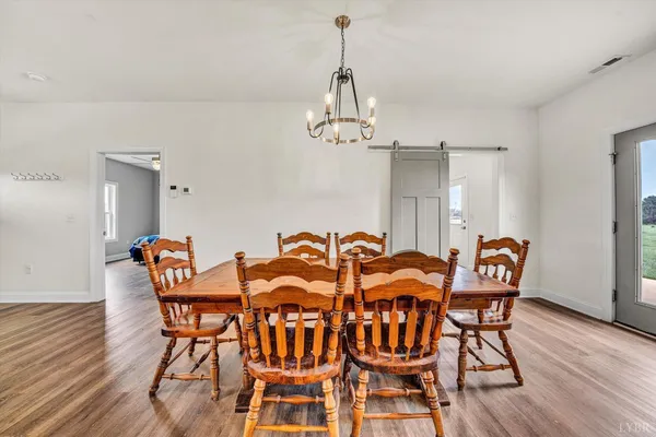 a view of a dining room with furniture wooden floor and chandelier