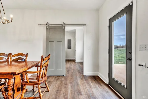 a dining room with furniture and wooden floor